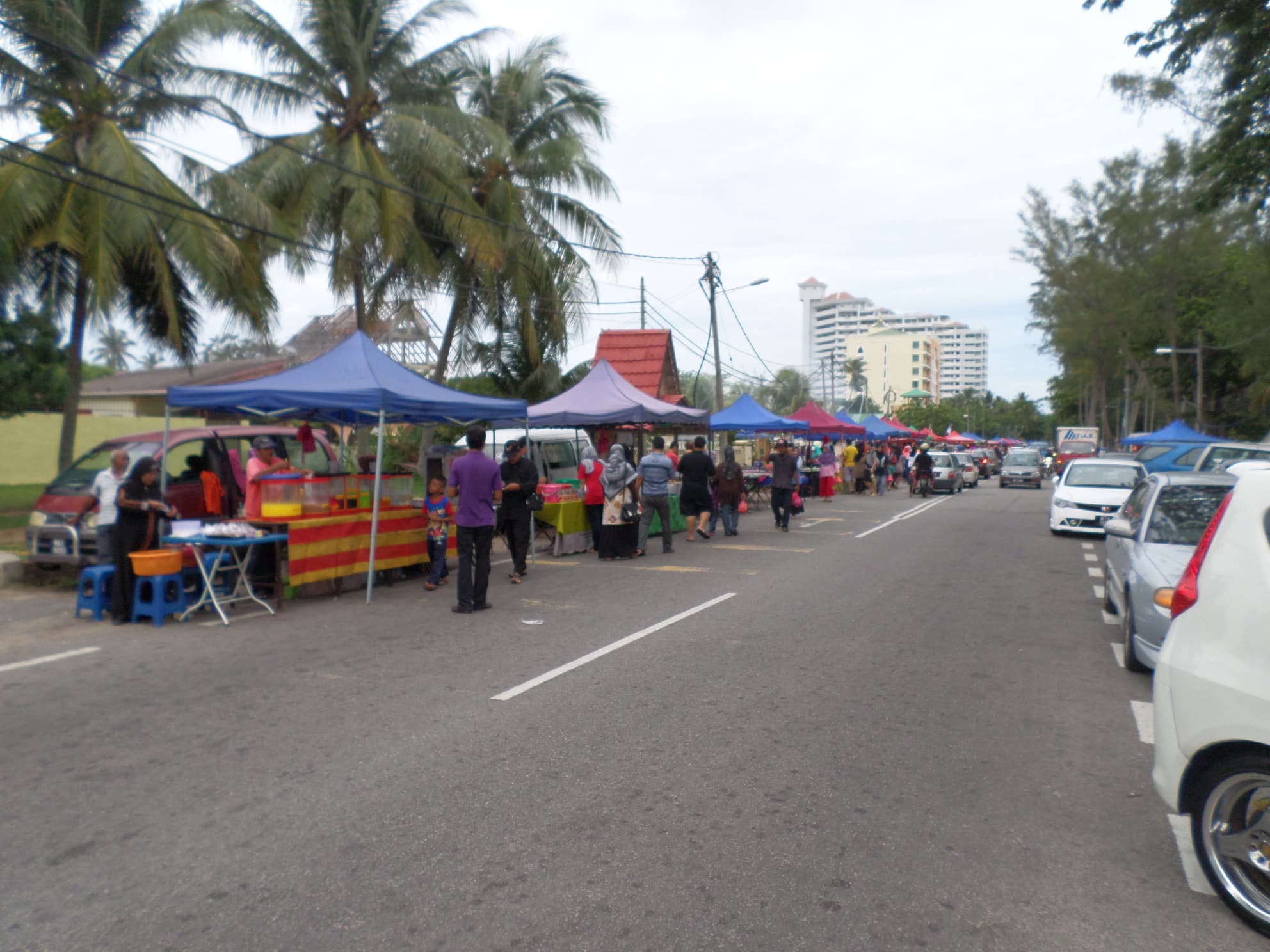 A Malaysian beach night market with food stalls and evening lights