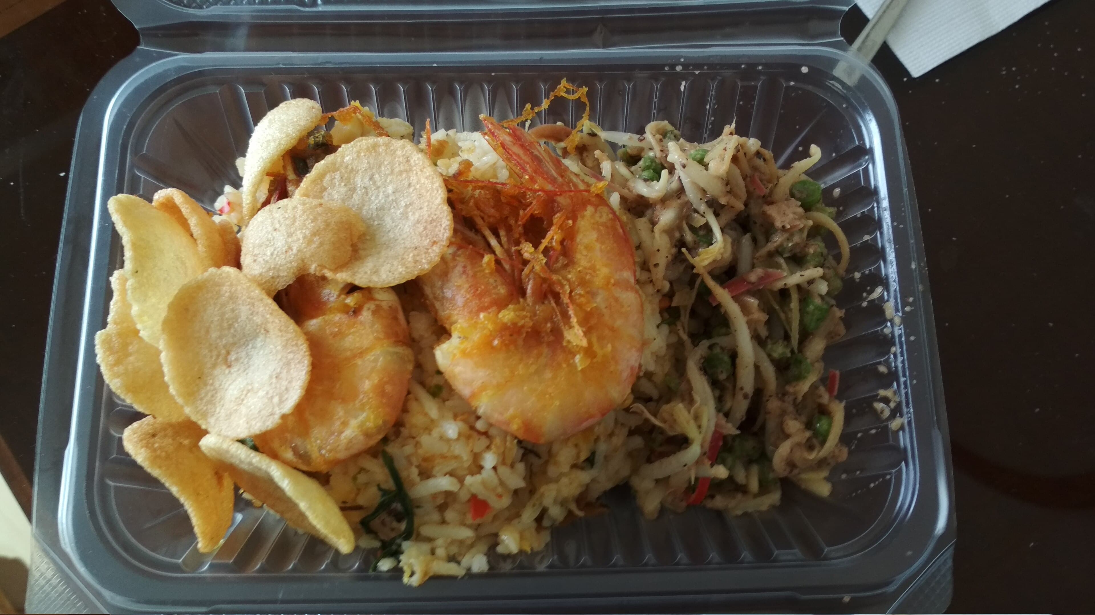 Malaysian fried rice served with fried prawns and prawn crackers